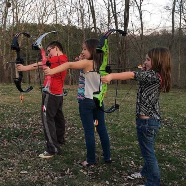 BTB Member Carlee shows some beginners how to shoot a bow.